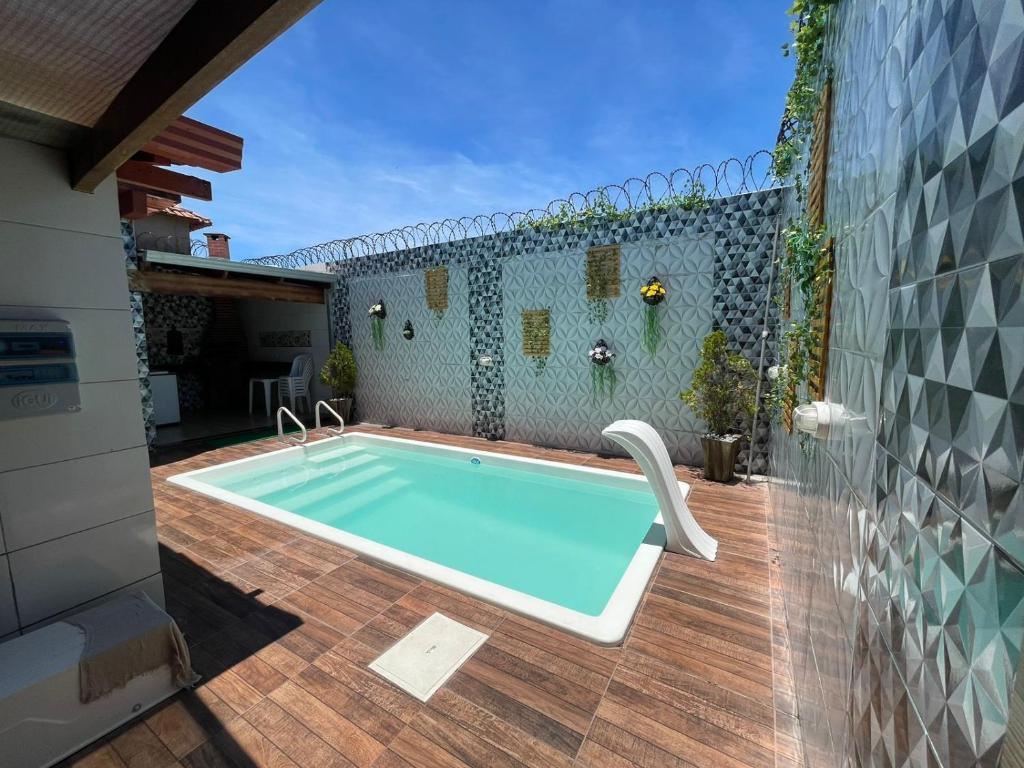 a swimming pool in the backyard of a house at Casa com Piscina em Prado Bahia in Prado