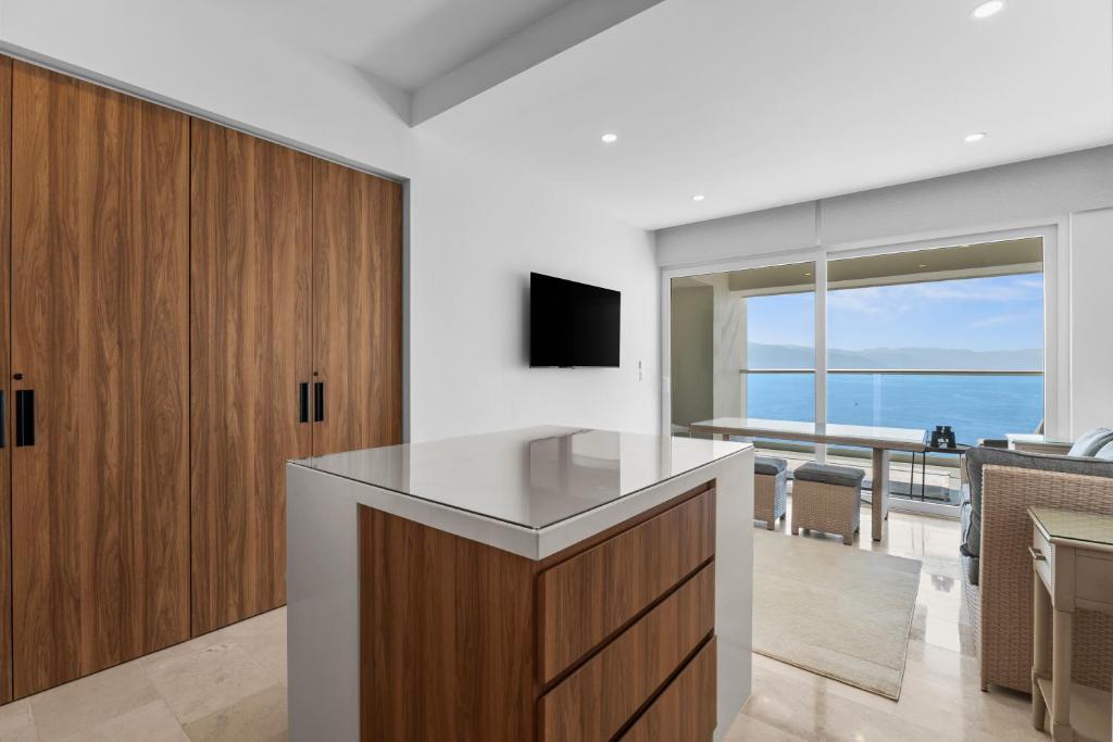 an open kitchen with a view of the ocean at Casa Corazon at Harbor 171 North Tower in Puerto Vallarta