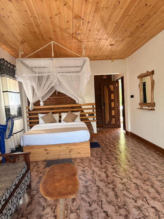 a bedroom with a large bed with a canopy at Mountain Shack Homestay in Ella