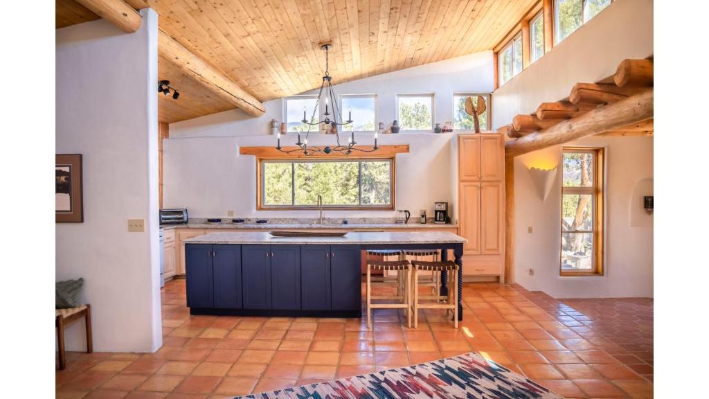 a kitchen with a blue island and a window at Casa Angel in Valdez