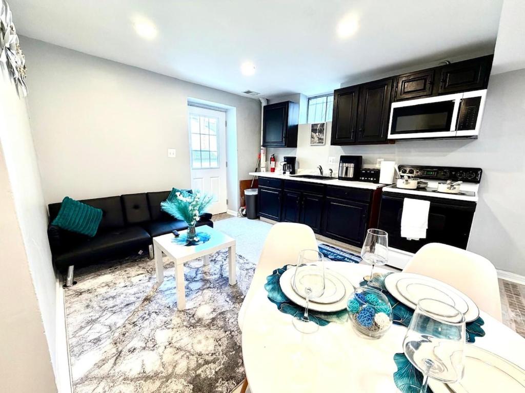 a kitchen and living room with a table and a couch at Prime DMV Stay in Silver Spring