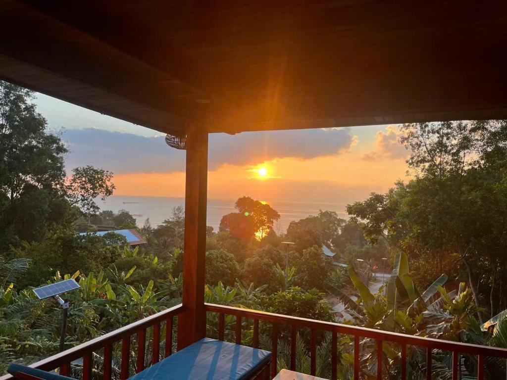 a view of the sunset from the porch of a house at COZY HOME PHU QUOC in Phú Quốc