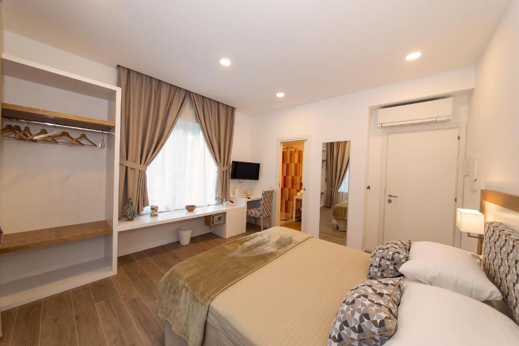 a bedroom with a bed and a window at Dea Guest House in Sorrento