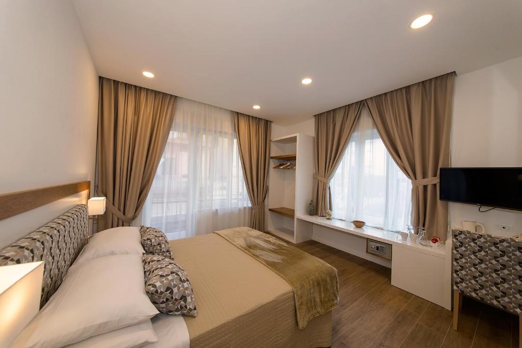 a hotel room with a bed and a television at Dea Guest House in Sorrento