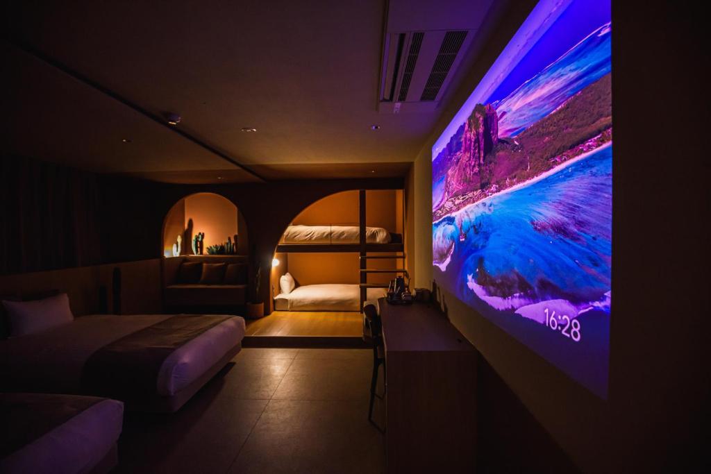 a bedroom with a large tv and a bed at SABLIER by R HOTEL in Osaka