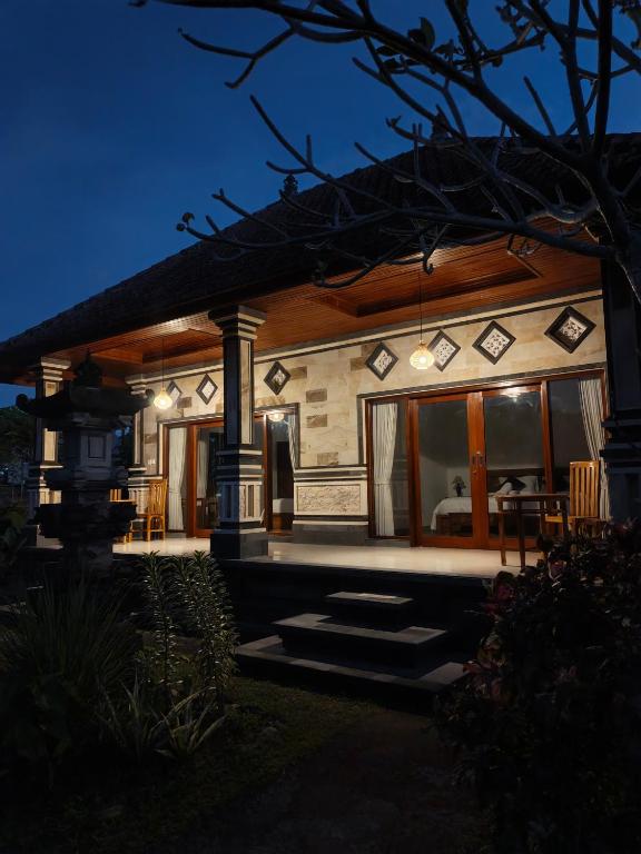 a house at night with lights on the front at Okasarna Guesthouse in Sidemen