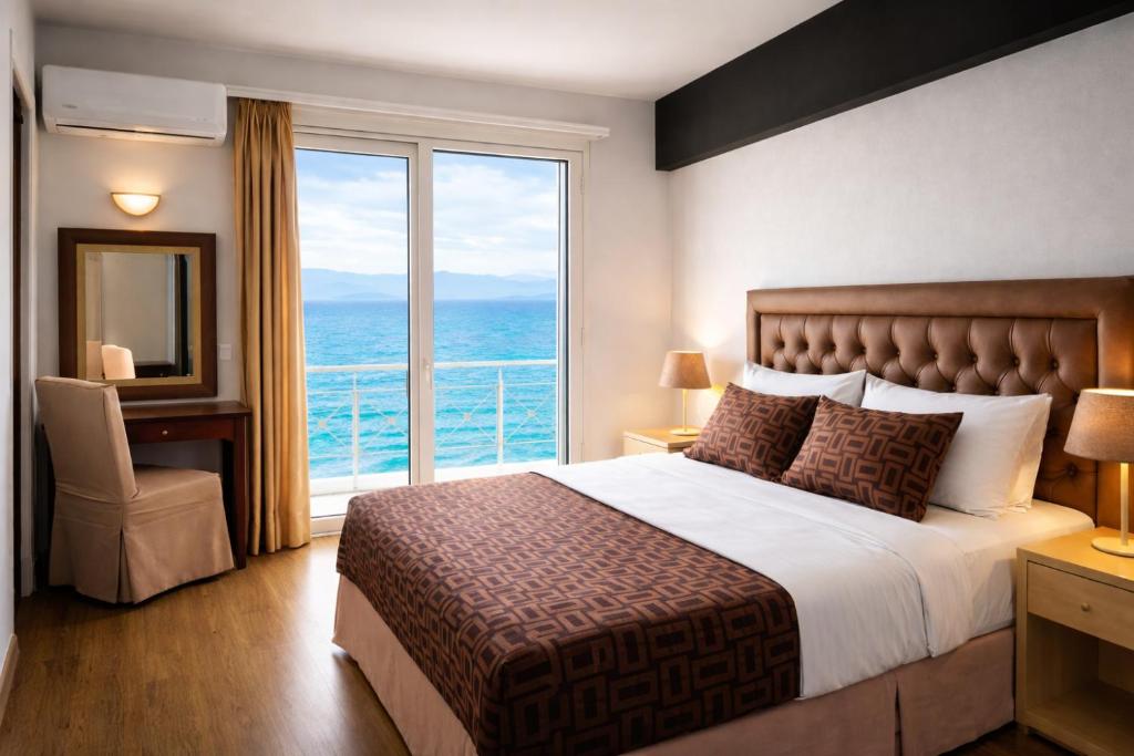 a hotel room with a bed and a large window at Queens Leriotis Hotel in Piraeus