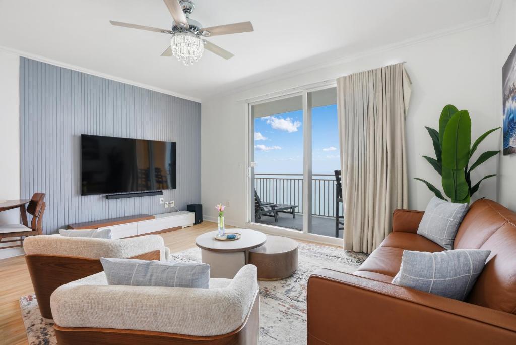 a living room with a couch and a tv at Splash Resort, 16th floor, Oceanfront, 1BR Sleeps 6, Lazy River & Water Park in Panama City Beach