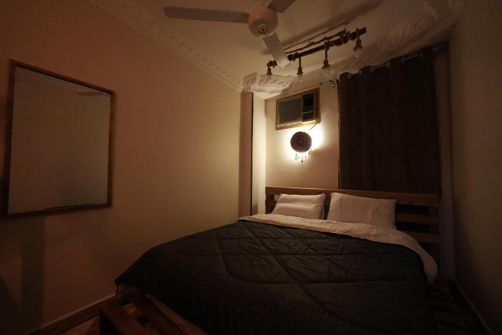 a bedroom with a bed with a ceiling fan at ABo ZAIN HOSTEL in Aswan
