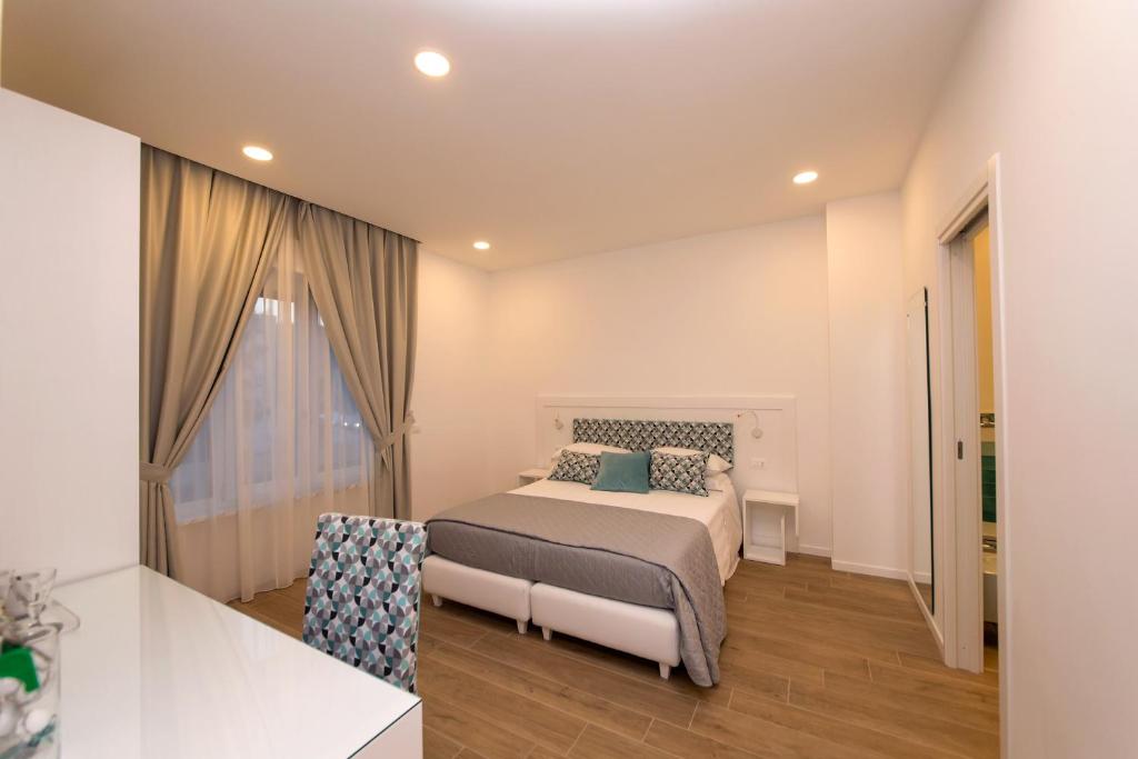 a small bedroom with a bed and a window at Dea Guest House in Sorrento