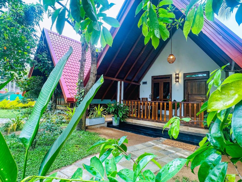 a house with a colorful roof at Oak Haven Cabana Sigiriya in Sigiriya