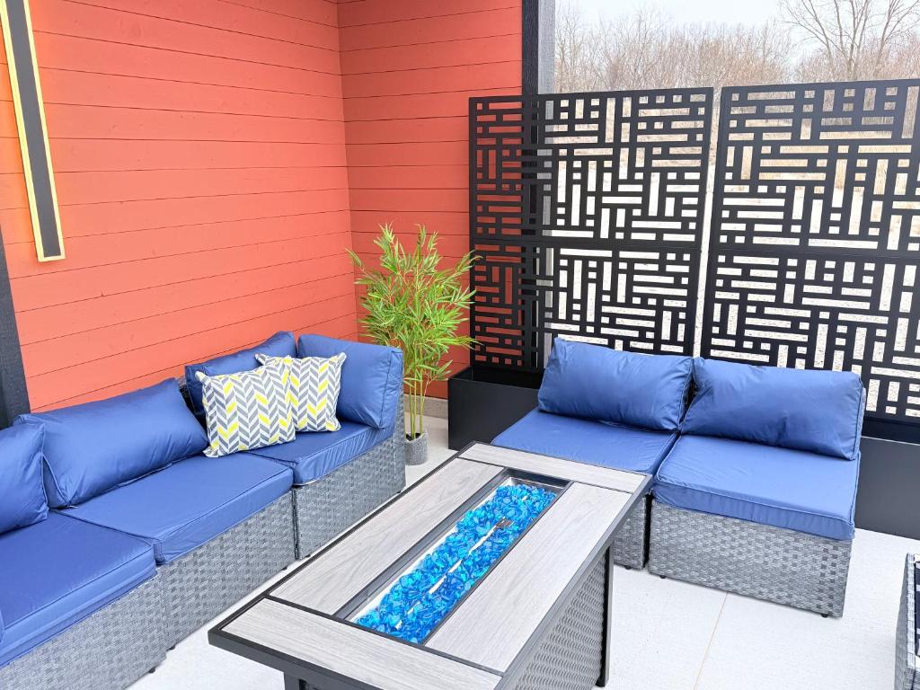 a patio with two blue couches and a table at The Sandpearl in Stevensville