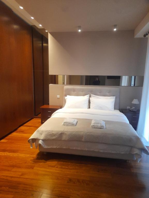a bedroom with a large white bed in a room at Kings and Queens 2 in Larisa