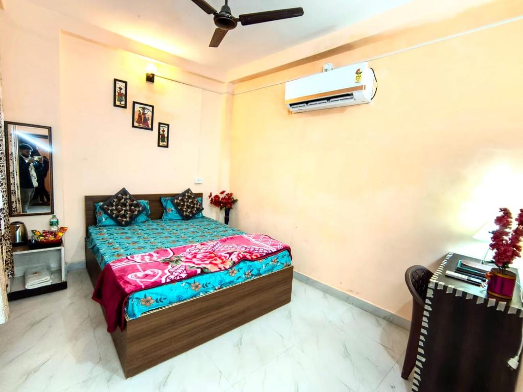 a bedroom with a bed and a tv on the wall at Shivashrays Homestay in Rānchī