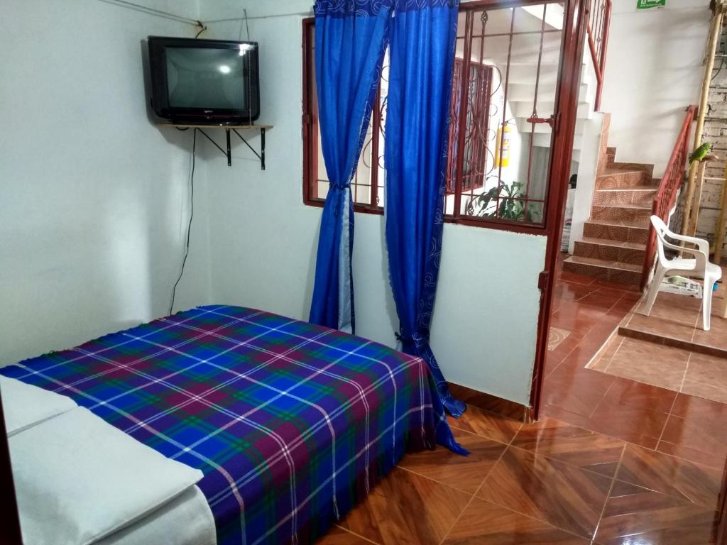 A bed or beds in a room at Hotel El Turista