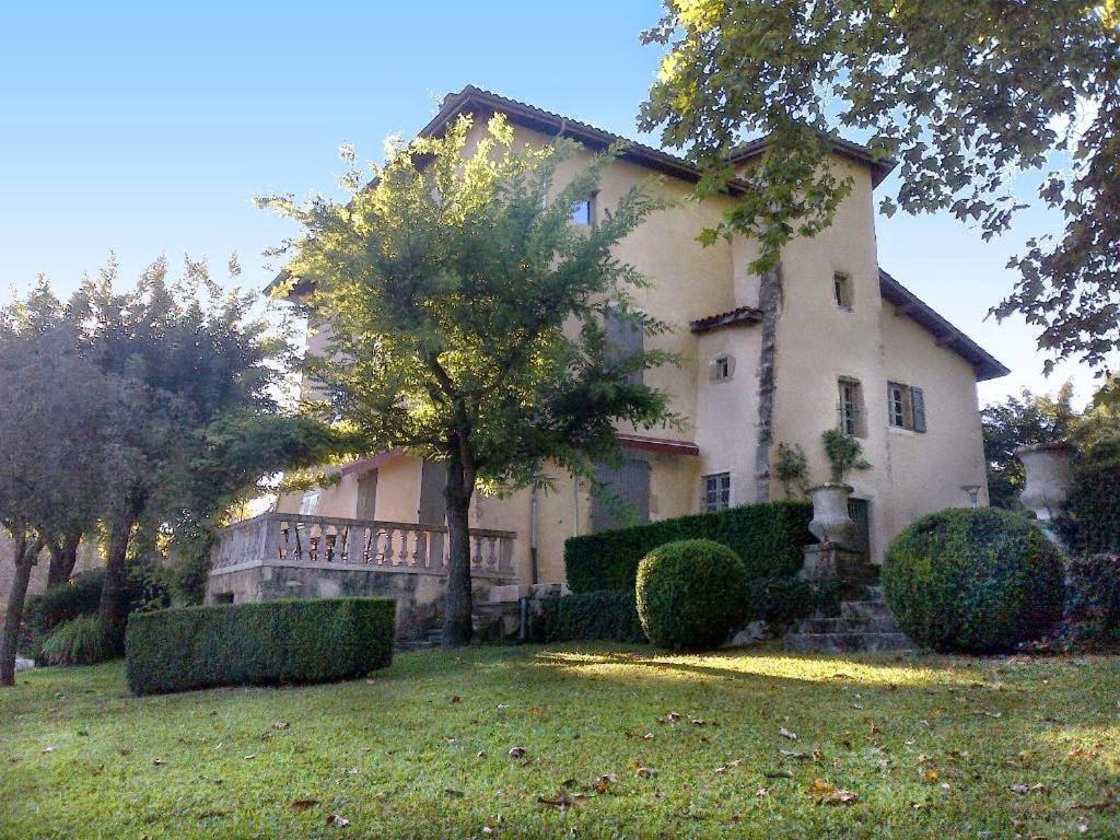 a large house with a tree in the yard at Maison de Manne in Saint-Just-de-Claix