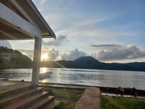 a house with a view of a lake with mountains at Saumualevu in Kavala