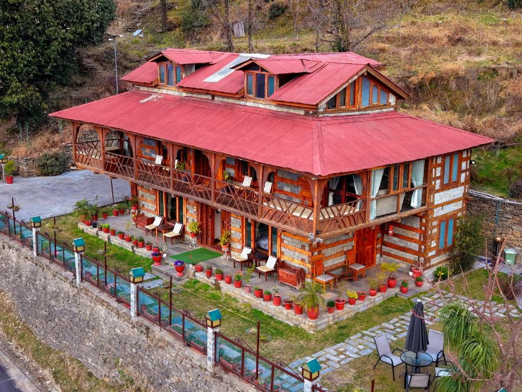 an overhead view of a house with a red roof at Himalayan Kothi ,Kais, Kullu Manali in Kulu