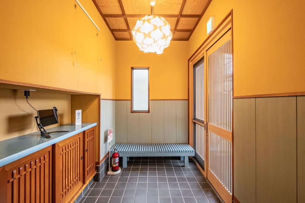 a hallway with a bench in a prison cell at Dream Bridge Fuji House in Fuji