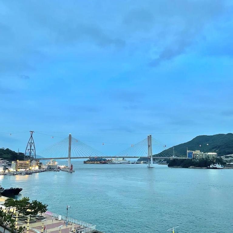 a bridge over a river with a bridge in the background at Yeosu Sun Beach Pension in Yeosu