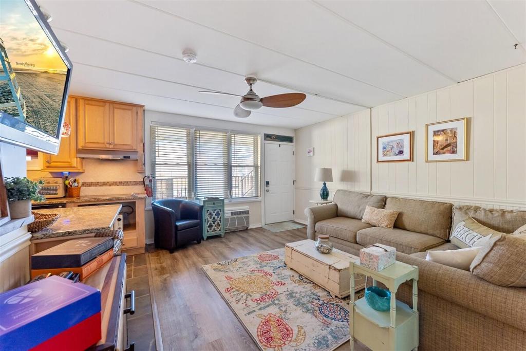 a living room with a couch and a table at Surfside Getaway with Heated Pool & BBQ Grill in North Wildwood