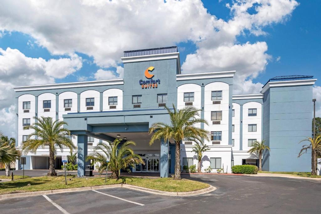 a large white building with a sign on it at Comfort Suites West Jacksonville in Jacksonville