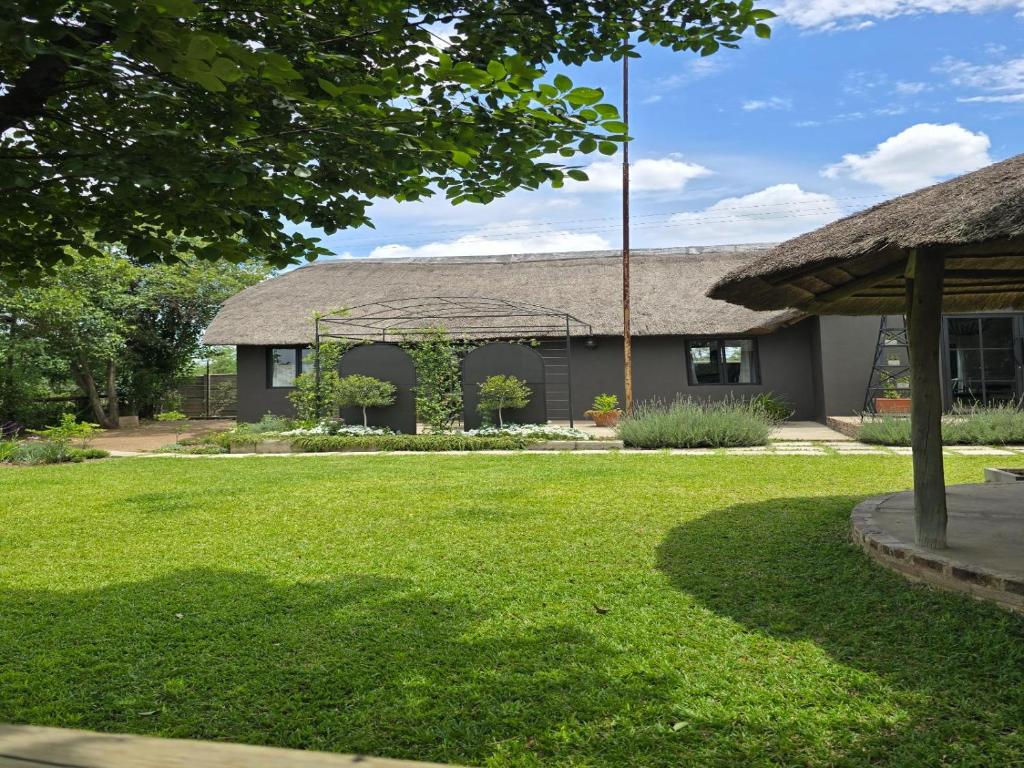 a house with a grass yard in front of it at The House On The Hill in Lanseria