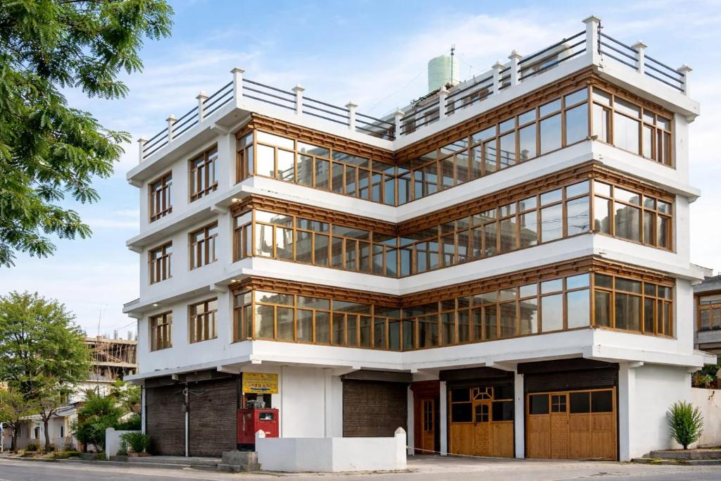 a tall building with glass windows at The Ladakh Residency Kargil in Kargil