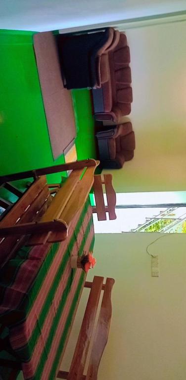 a painting of a bedroom with a bed and a green wall at New mount villa in Hatton
