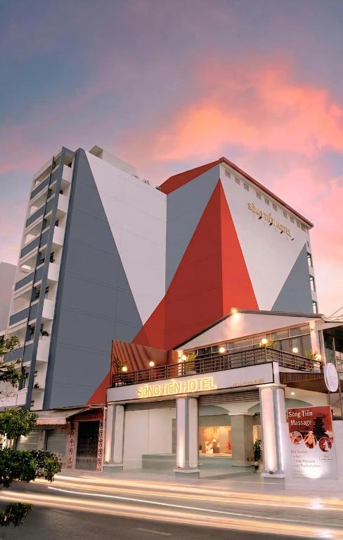 a building with a large pyramid in front of a street at Song Tien Hotel in Mỹ Tho
