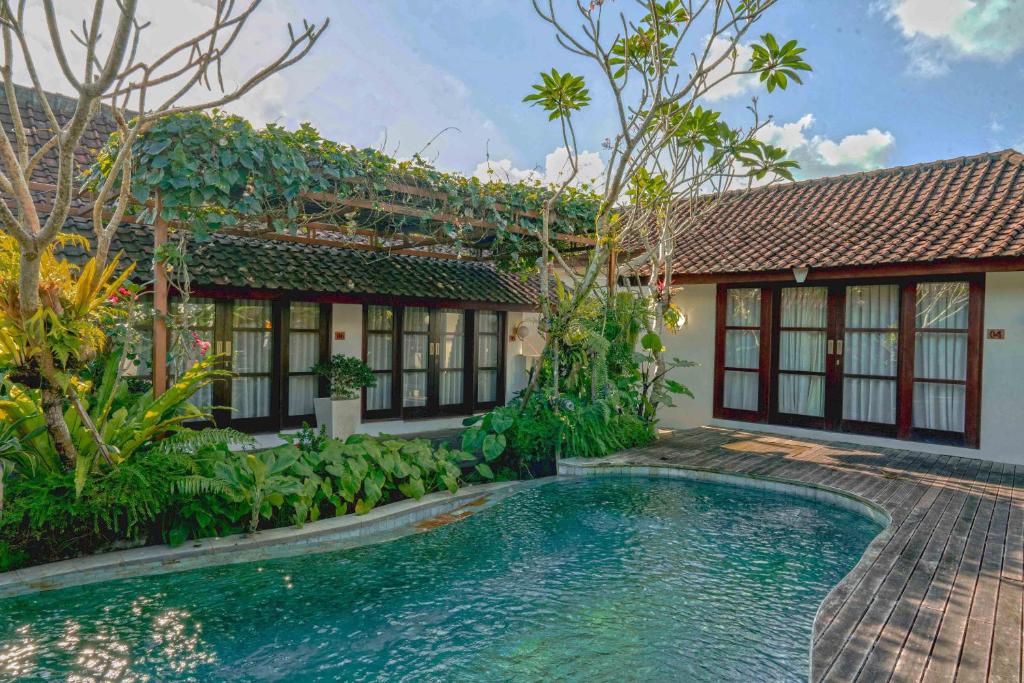 an image of a house with a swimming pool in front of it at Goya Courtyard Ubud in Ubud