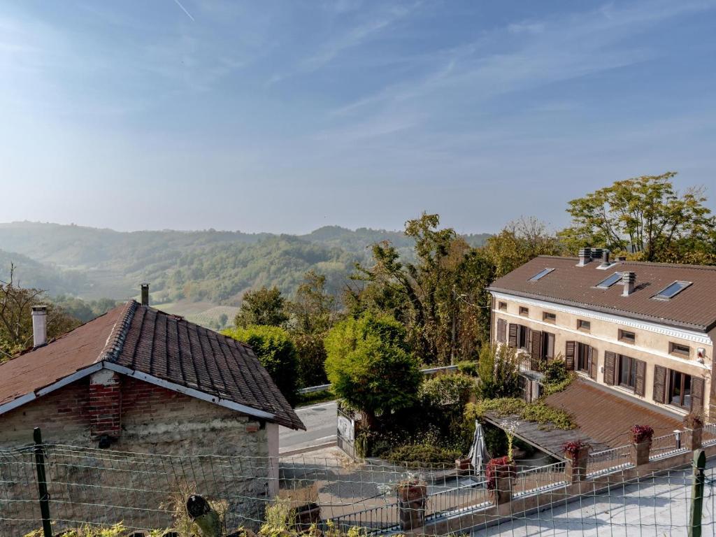 an aerial view of a house with mountains in the background at Villa Floro in Azzano d'Asti