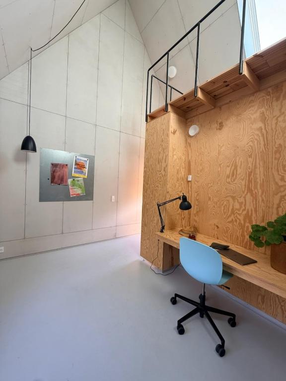 an office with a desk and a blue chair at 44Møen in Askeby
