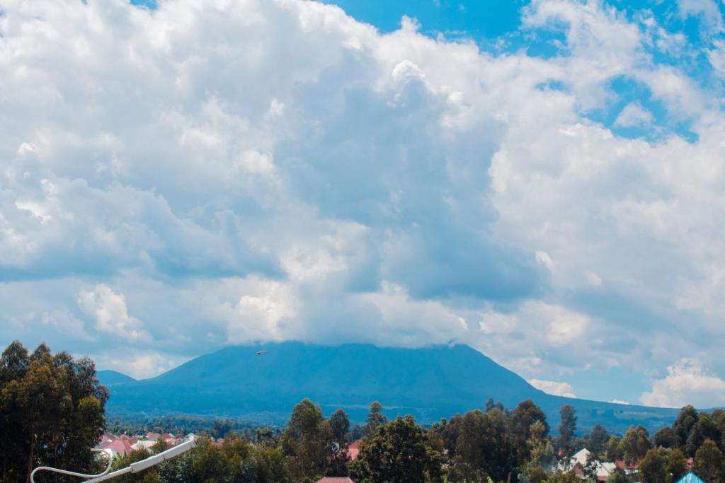 a view of a mountain under a cloudy sky at Fido's Guesthouse in Ruhengeri