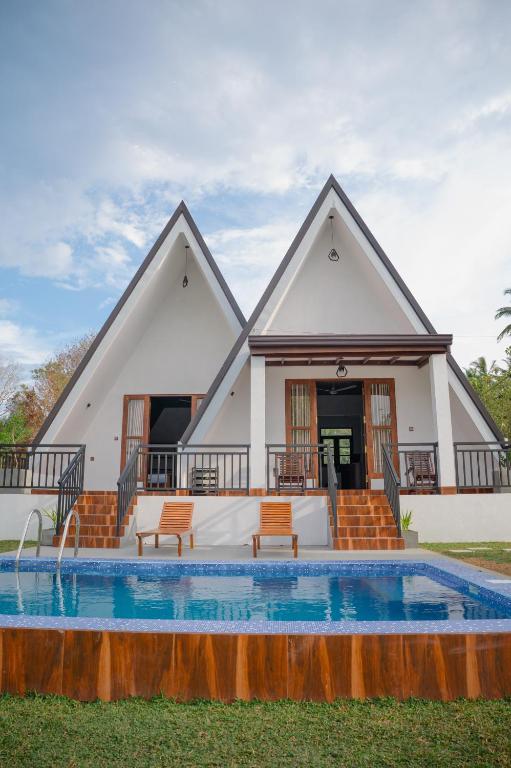 a villa with a swimming pool and a house at King coco villa in Tangalle