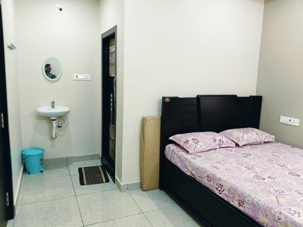 a bedroom with a bed and a sink at Sri Datta Paduka Nivas in Pithāpuram