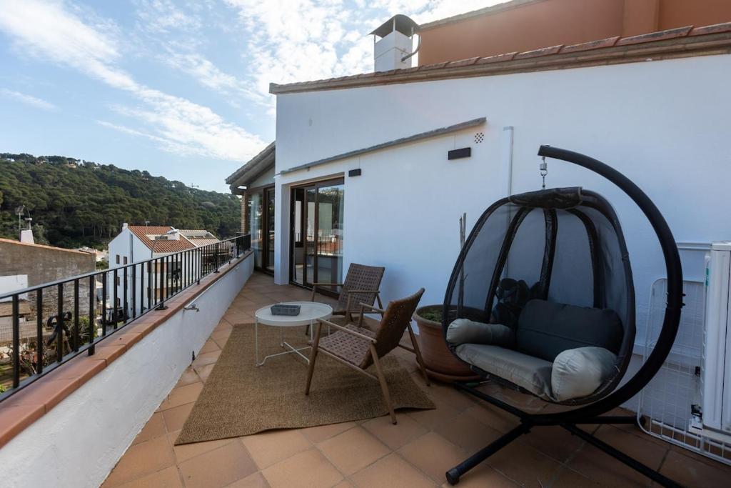 a balcony with a couch and a swing at Seamount, studio 3 mins from Tamariu beach in Tamariu