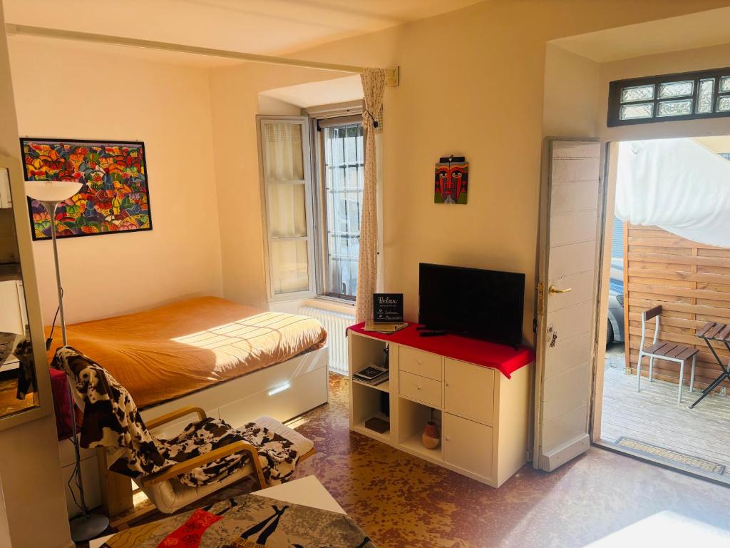 a small bedroom with a bed and a television at Friendly Africa Room Como Center in Como