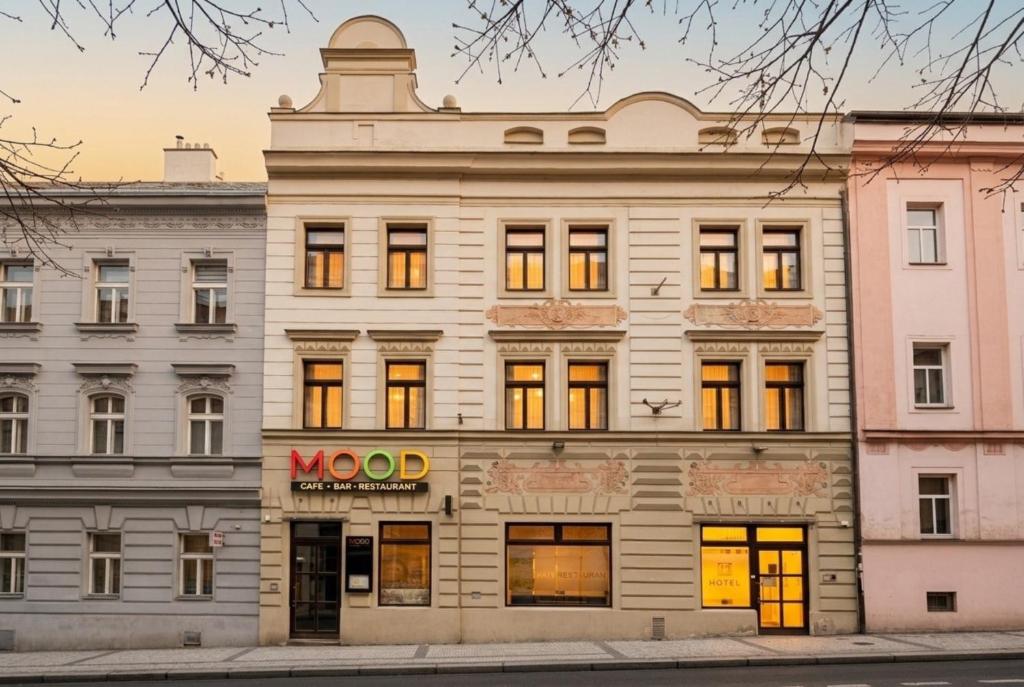 a large white building with a mood sign on it at Hotel Hartig in Prague