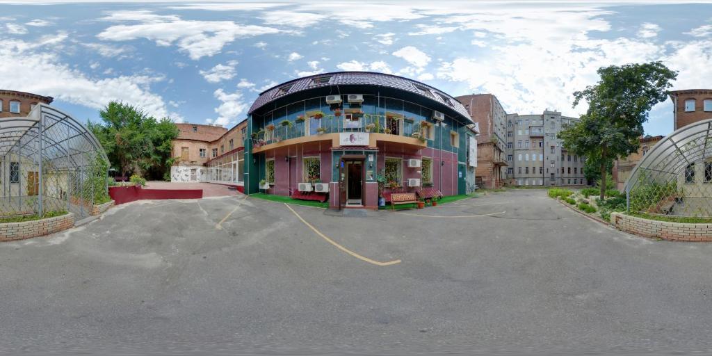 a large building in a parking lot in front at YELLOW UNLIMITED HOTEL 4 in Kharkiv