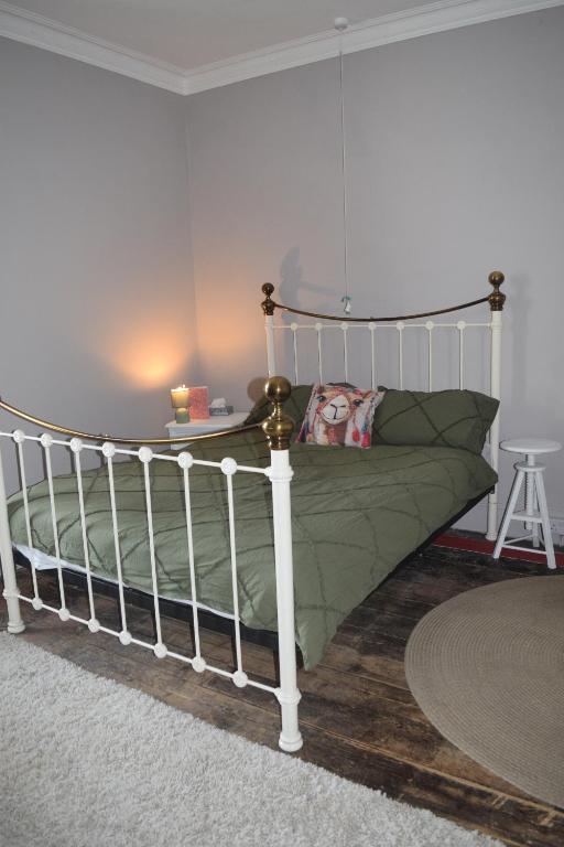 a bedroom with a bed with a white frame at Gorffwysfa Hideaway Double 1st floor in Pwllheli