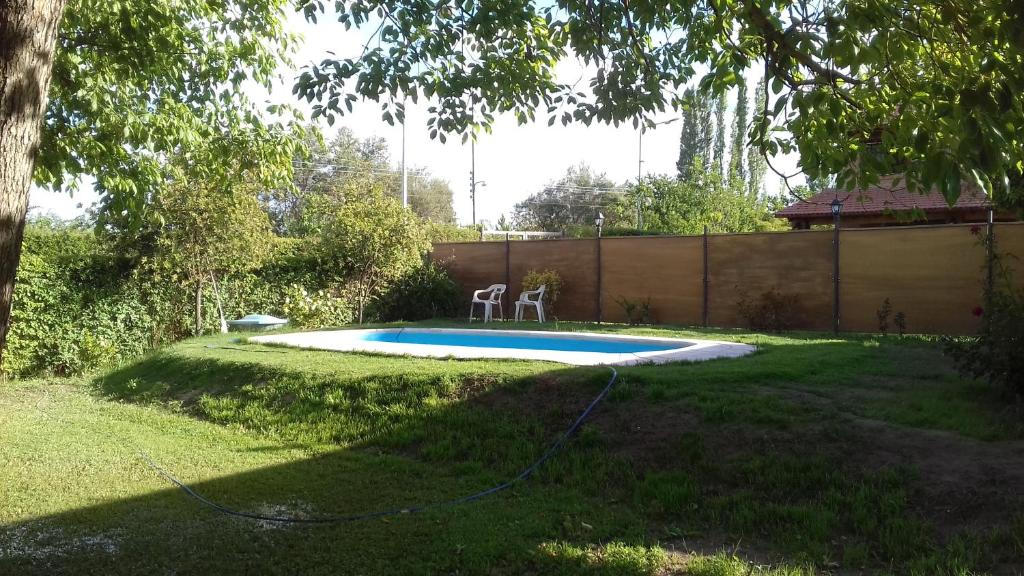 una pequeña piscina con 2 sillas en un patio en La Quinta en Maipú