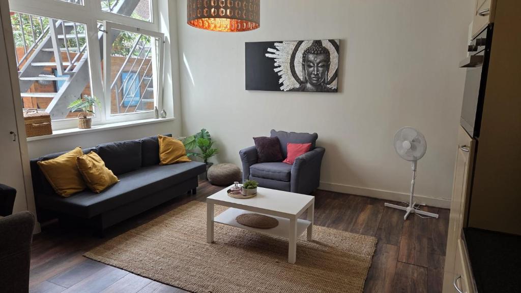 a living room with a couch and a table at Perfectly Located, Surprisingly Quiet in Gouda