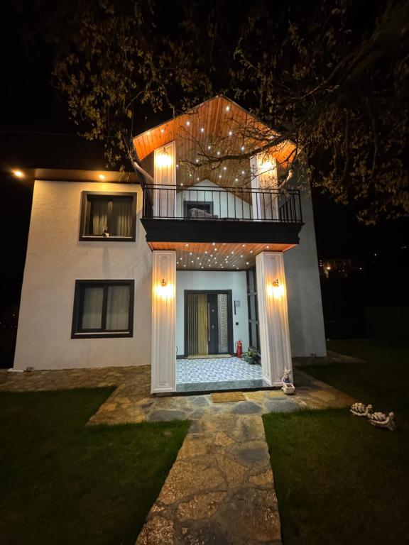 a house at night with lights on the front of it at Yeşilyurt villa in Sapanca
