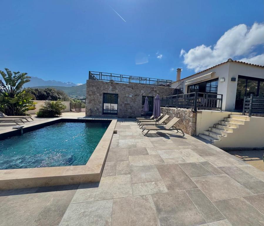 a villa with a swimming pool and a house at Villa casa Luna piscine chauffée vue mer proche centre et plage de Calvi in Calvi