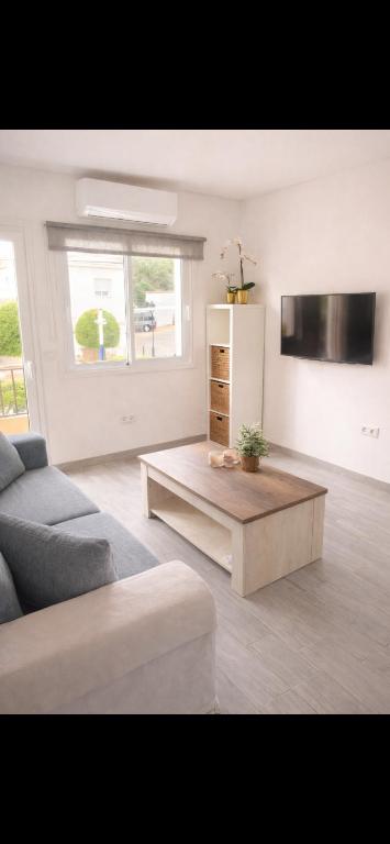 a living room with a couch and a coffee table at Beachfront Studio in Castillo de la Duquesa in Castillo de Sabinillas