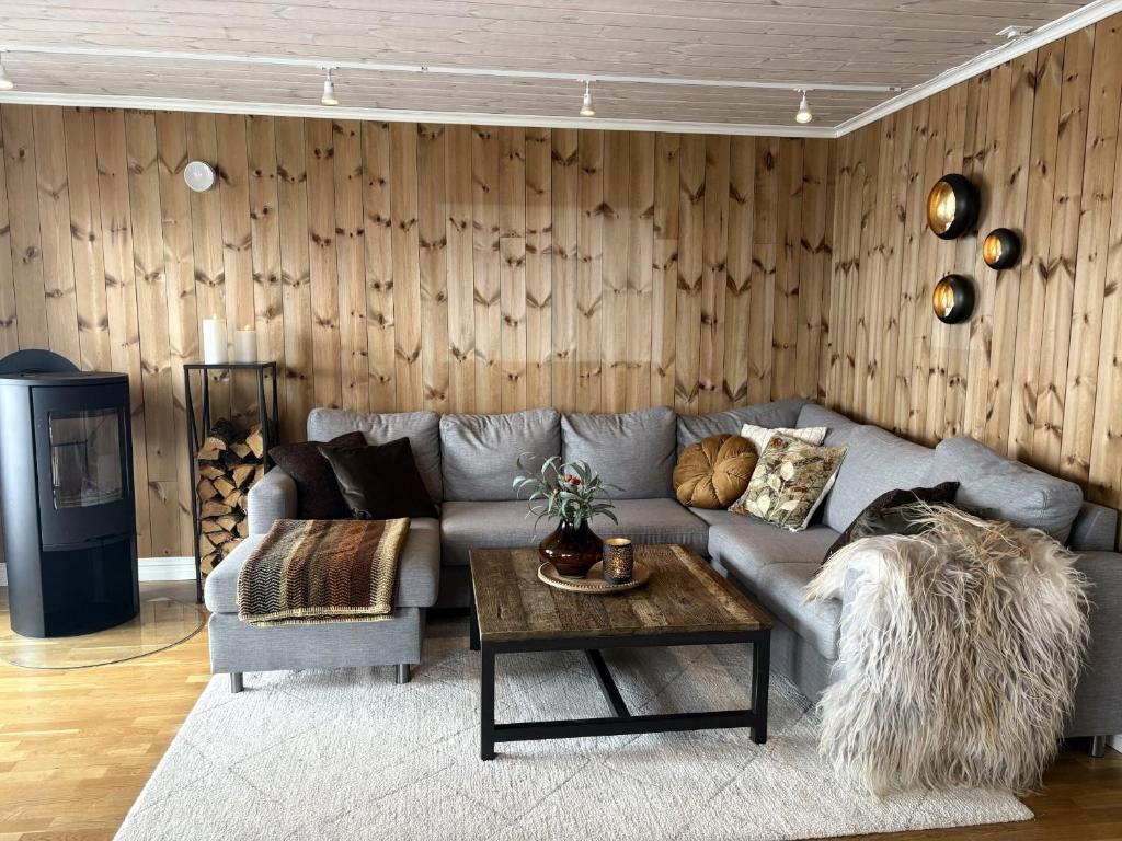 a living room with a couch and a table at Lastølen Snr6 nr2 in Sykkylven