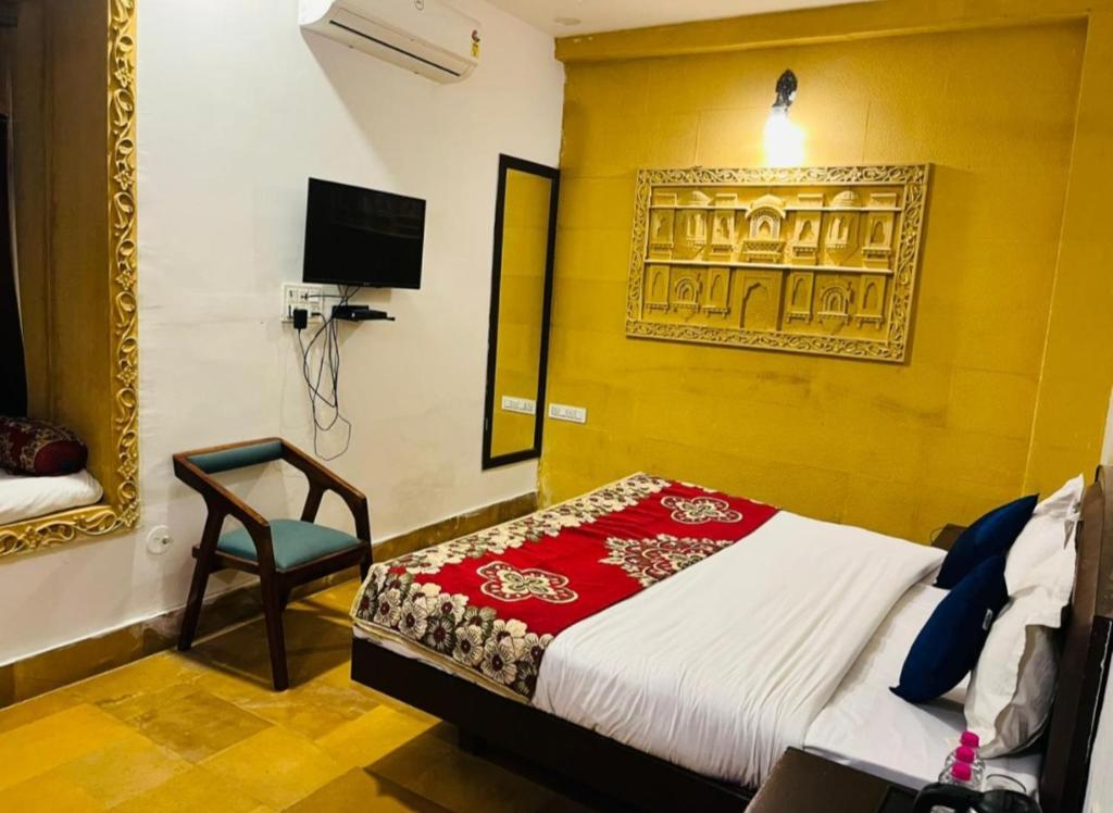 a bedroom with a bed and a chair in a room at Hostel stay bless in Jaisalmer