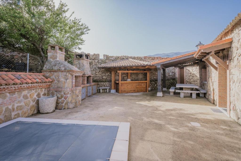 an outdoor patio with a basketball court and a building at El Cauce in Navaluenga
