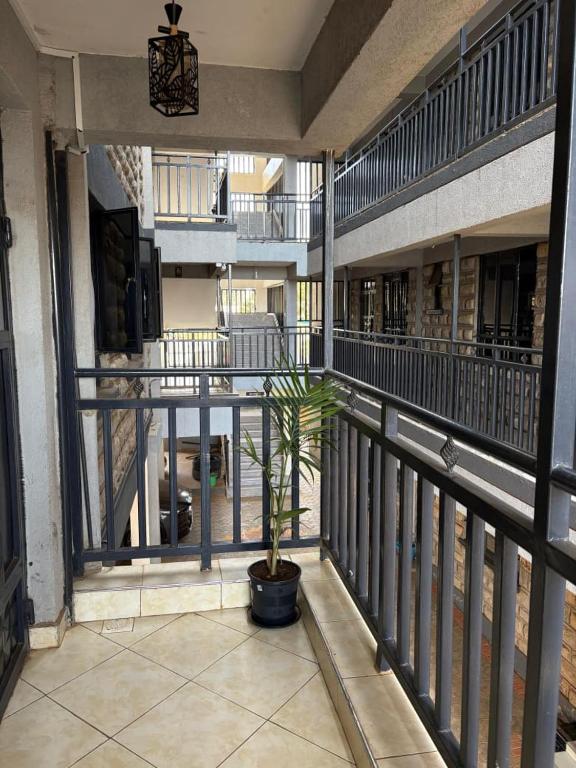 a plant in a pot on a balcony of a building at Primestay Suites in Eldoret